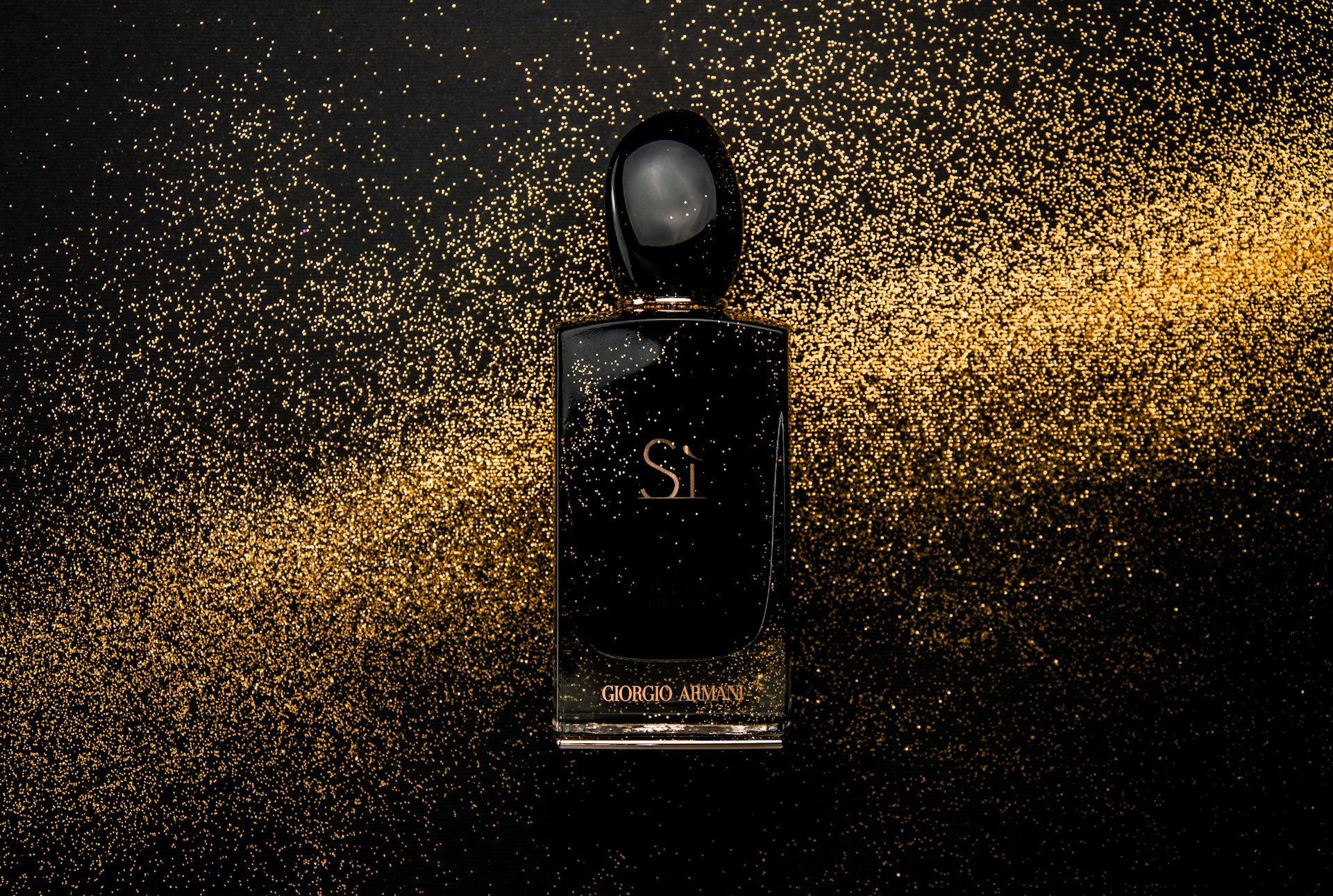 black glass perfume bottle showing front label